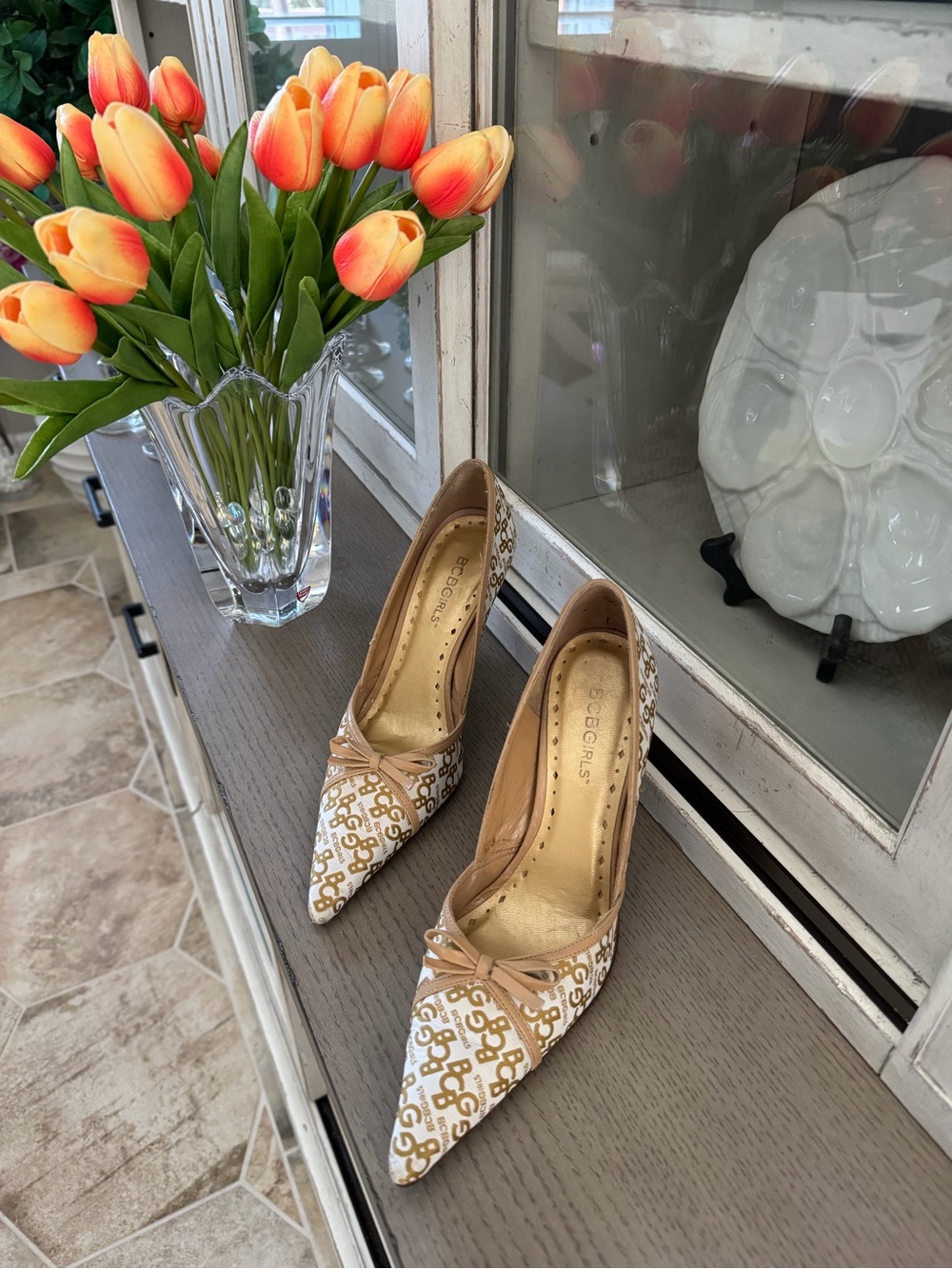 BCBG White & Tan Logo Pointed-Toe Heels with Bow Accent